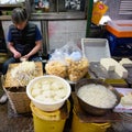 Marketeer prepares tofu and germination in street market of Hong Kong