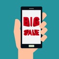 Marketing and advertisement. Hand holding smartphone with big sale concept shows on screen. Royalty Free Stock Photo