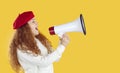 Woman using megaphone to announce discounts and sales, isolated on orange background. Royalty Free Stock Photo