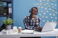 Marketing company office cheerful worker wearing modern wireless headphones Royalty Free Stock Photo