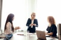 Marketing experts sit around table and looking at woman speaker at meeting. Royalty Free Stock Photo