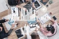 Marketing Strategy Session with Data Analysis and Charts in a Collaborative Workspace Overhead View Impute Royalty Free Stock Photo