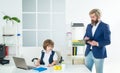 Marketing team meeting brainstorming research. Cute kid sitting in office chair self confident like big boss, funny Royalty Free Stock Photo