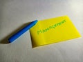 marketing text displayed on yellow paper slip with blue color pen Royalty Free Stock Photo