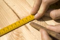 Marking distances. The carpenter`s hands measure distance measure. Royalty Free Stock Photo