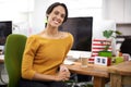 Marking her mark in the creative industry. Cropped view of a young designer working in the office with a smile. Royalty Free Stock Photo