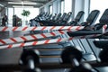 Marking tape on treadmill machines in gym, safe distance and coronavirus concept. Royalty Free Stock Photo