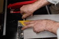 Marking tiles for cutting with an electric tile cutter yellow ruler Royalty Free Stock Photo