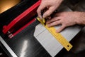 Marking the tiles with a yellow ruler and a pencil for cutting with an electric tile cutter Royalty Free Stock Photo