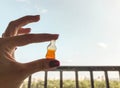 Marmalade candies. a girl with a red manicure holds sweets in the shape of a bottle with lemonade. candies on a background of blue