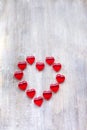 Marmalade in the form of hearts laid out in the shape of a large heart on wooden boards