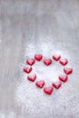 Marmalade in the form of hearts laid out in the shape of a large heart on wooden boards