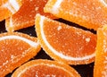 Marmalade in the form of lobes of orange on a black background Royalty Free Stock Photo