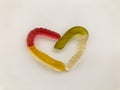 Marmalade worms. gelatinous worms, multi-colored intertwined in the shape of a heart. bright and tasty gelatinous high-calorie