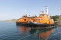 Two orange black work boats belonging to BOTAS company waiting at the port of marmara