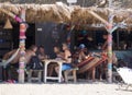 Marmari, Evia island, Greece. August 2020: Holidaymakers and tourists relax on beach loungers and in cafes on the beach on the Gre