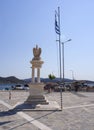 Marmari, Evia island, Greece. August 2020: monument in the form of an eagle on a column and a Greek flag on the embankment with fi