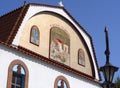 Marmari, Evia island, Greece. August 2020: Mozaika on St. George`s Church with a chapel and bell tower on the waterfront of the r