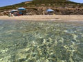 Marmari, Evia island, Greece. August 2020:  View of a Grand sandy beach in the Aegean sea with holidaymakers and tourists on the G Royalty Free Stock Photo