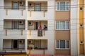 MARMARIS, TURKEY: A woman shakes a dirty carpet from the balcony of a multi-storey building.