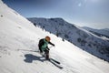 Marmaros, The Carpathians, UKRAINE - March 15 2021: Female skier skiing downhill during sunny day in high mountains Royalty Free Stock Photo