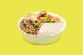 Marmita or marmitex, Brazilian home-delivered lunch meal, with rice, chicken thigh, farofa and salad, beans, copy space, yellow