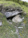 Marmot burrow under some rocks in the alps looks like a little troll cave Royalty Free Stock Photo