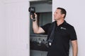 Maroochydore, Australia - March 5, 2020. Young Male Pest Control Worker checking apartment with FLIR E6 thermal imaging