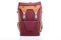 maroon backpack with buckles, standing on white