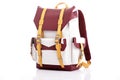 maroon backpack with buckles, standing on white