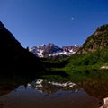 Maroon Bells and starry sky reflection in lake at night. Royalty Free Stock Photo
