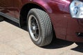 Maroon car wheel under the bright sun