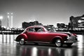 Maroon classic car on black and white background
