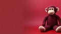 Maroon Knitted Monkey Toy On Maroon Background