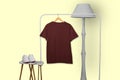 Maroon t-shirt hanging on rack display isolated on white background Royalty Free Stock Photo