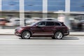 Maroon Volkswagen Touareg car moving on the street, side view