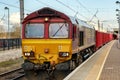 A maroon and yellow diesel freight locomotive