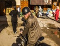 Marrakech; may, 14, 2016: angry Moroccan man riding a motorcycle down a street in Marrakech in Morocco