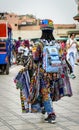 Back view of a Moroccan male vendor selling colorful clothes at Marrakech Jemaa el-Fnaa Square