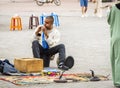 A Moroccan male snake charmer playing instrument with his snakes in Marrakech Jemaa el-Fnaa Square Royalty Free Stock Photo