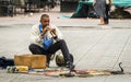 A Moroccan snake charmer playing instrument with the snakes in Marrakech Jemaa el-Fnaa Square Royalty Free Stock Photo