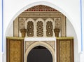 The view of an ancient door with Moroccan style decorative details under an arch wall