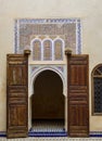 An ancient door with wooden frame and decorative details inside Marrakech Bahia Palace