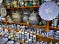 Marrakech, Morocco - January 1st, 2020: Handmade colourful decorated plates and bowls or cups on display at traditional souk - Royalty Free Stock Photo