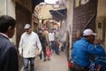 Marrakech, Morocco-November 06, 2019: Moroccan city landscape. Crowd of people walking through the narrow streets of old buildings Royalty Free Stock Photo