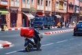 MARRAKESH, MOROCCO - JUNE 05, 2017: Courier rides a motobike with home delivery box on the road in Marrakech