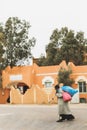 Poor homeless lonely beggar walking by moroccan street in Marrakech with bags