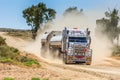 Dirt road with road train in Australian Outback surrounded by huge dust clouds