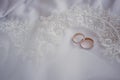 Marriage concept. Golden wedding rings on white veil. Close-up. Space for text. Top view Royalty Free Stock Photo