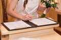 Marriage elegant bride signing register, holding pen and official document wedding couple Royalty Free Stock Photo